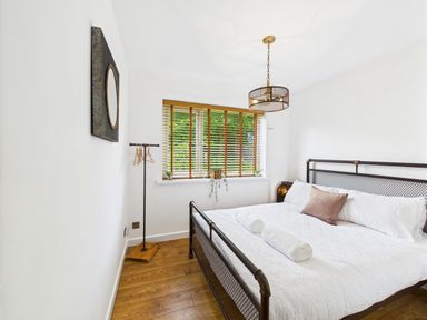 A bedroom with a bed and window at 59a Gwscwm Road