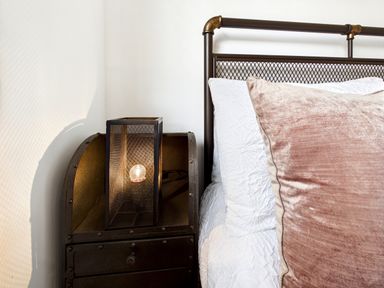 A bedroom with a bed and lamp on a nightstand at 59a Gwscwm Road