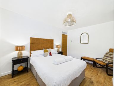 A bedroom with a bed and lamps at 59a Gwscwm Road