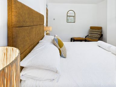 A bedroom with a bed and a chair at 59a Gwscwm Road