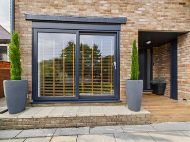 An entrance area with sliding door and plant pots at 59a Gwscwm Road
