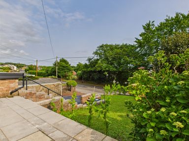 A garden with steps and grass near a road at 59a Gwscwm Road