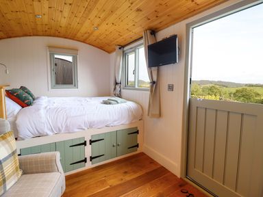 A bedroom with a bed and television at Charollais in Oswestry