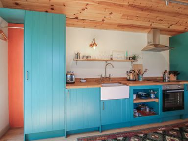 A kitchen with a sink and cooking appliances at Squirrel's Drey Chapel Lawn near Clun