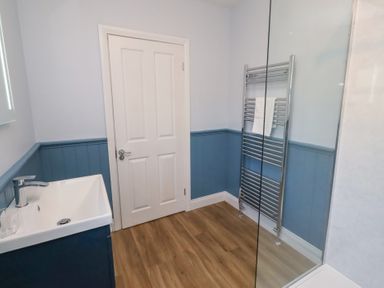 A bathroom with a sink and towel rail at Linn Cottage in Hexham