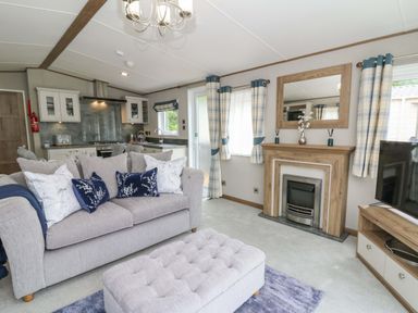 A living room with a sofa and television at The Beaumont No 34 in New Quay