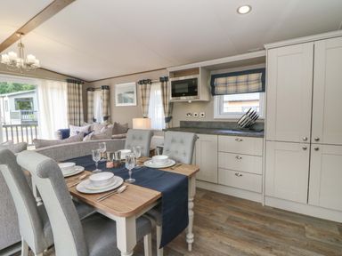 A dining room with a table and chairs at The Beaumont No 34 New Quay