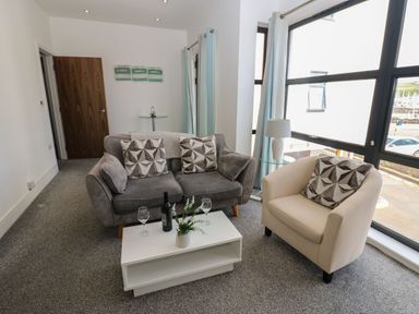 A living room with a sofa and armchair at Harbour View in Whitehaven