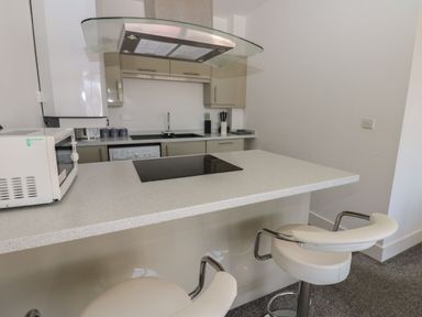 A kitchen with a microwave and stove at Harbour View in Whitehaven