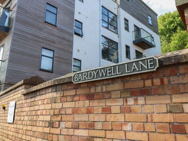 A sign for Bardywell Lane with a building in the background at Harbour View, Whitehaven