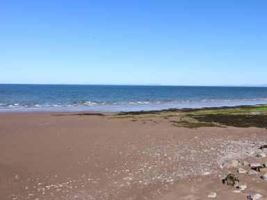 A beach with sand and sea at Harbour View in Whitehaven