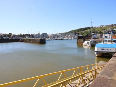 A harbor with boats and a railing at Harbour View in Whitehaven