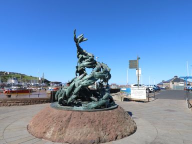 A sculpture near a marina with fishing boats at Harbour View in Whitehaven