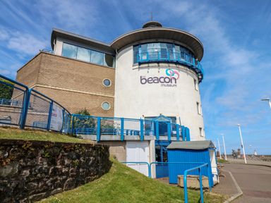 A museum building with a prominent sign and pathway at Harbour View, Whitehaven