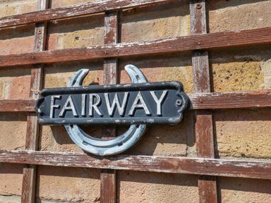 A decorative sign on a trellis wall at Fairways House in Weymouth