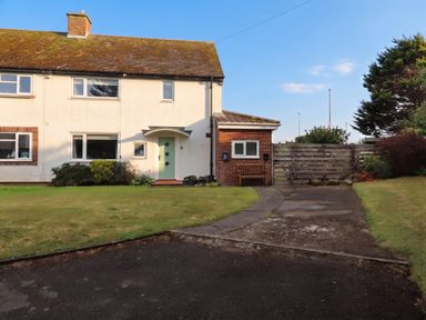 A house with a pathway and garden at Bari House in Seahouses