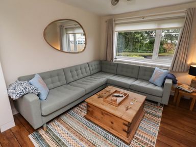 A living room with a sofa and coffee table at Bari House in Seahouses