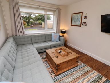 A living room with a sofa and coffee table at Bari House in Seahouses