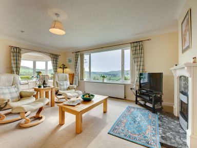 A living room with two armchairs and a coffee table at The Granary in Alnwick