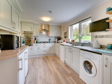 A kitchen with appliances and cabinets at The Granary in Alnwick