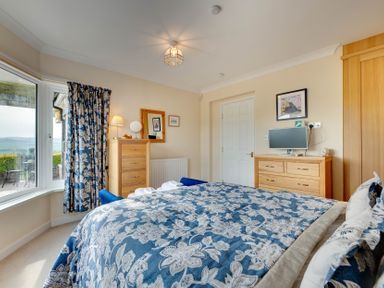 A bedroom with a bed and window at The Granary in Alnwick