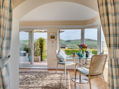 A dining room with a table and chairs at The Granary in Alnwick