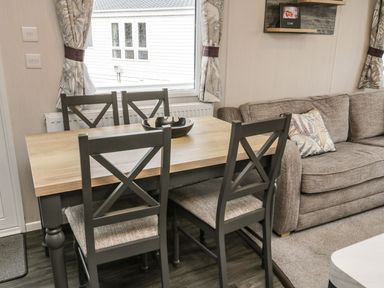 A dining room with a table and chairs at Kelly's Retreat in Scarborough