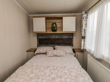 A bedroom with a bed and shelf at Kelly's Retreat in Scarborough