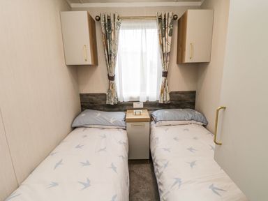 A bedroom with two single beds and a nightstand at Kelly's Retreat in Scarborough