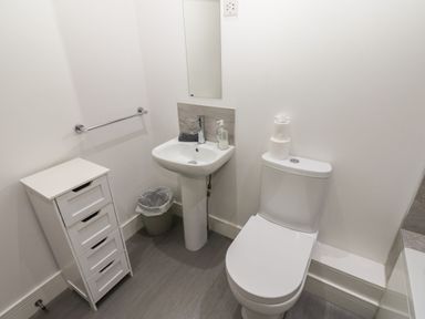 A bathroom with a toilet and sink at Harbourside Apartments in Whitehaven