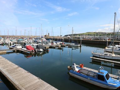 A marina with boats docked at Harbourside Apartments in Whitehaven