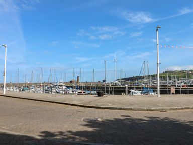 A marina with boats and light posts at Harbourside Apartments in Whitehaven