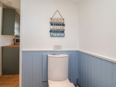 A bathroom with a toilet and sign at Stella Maris in Torpoint