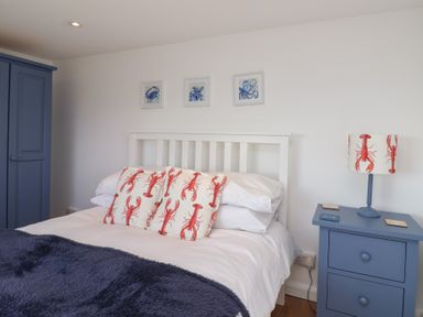 A bedroom with a bed and bedside table at Stella Maris in Torpoint