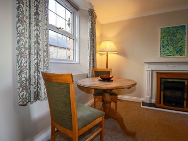 A dining room with a table and chairs at Horseshoe Cottage in Falmouth
