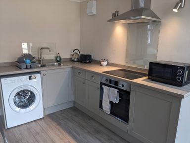 A kitchen with appliances and fixtures at Horseshoe Cottage Budock Water near Falmouth