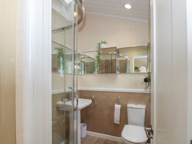 A bathroom with shower, sink, and toilet at Labernum in Lytham St. Annes
