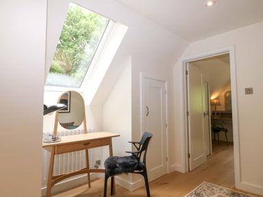 A bedroom with a desk and a chair at Lakeside Lodge in Witherenden Hill near Burwash