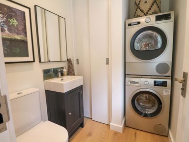 A laundry room with a washer and dryer at Lakeside Lodge Witherenden Hill near Burwash
