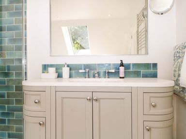 A bathroom with a sink and mirror at Lakeside Lodge in Witherenden Hill near Burwash