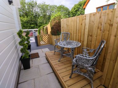 An outdoor space with a table and chairs at Pinecroft Annex Stepaside near Saundersfoot