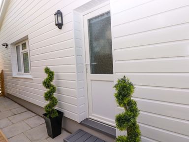 An entrance with a door and windows at Pinecroft Annex Stepaside near Saundersfoot