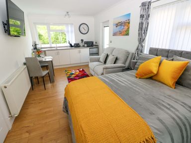 A studio with seating area and kitchen at Pinecroft Annex Stepaside near Saundersfoot