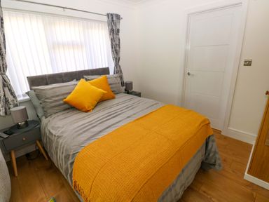 A bedroom with a bed and bedside tables at Pinecroft Annex Stepaside near Saundersfoot