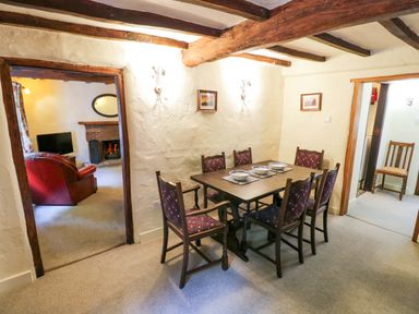 A dining room with a table and chairs at Fern Cottage