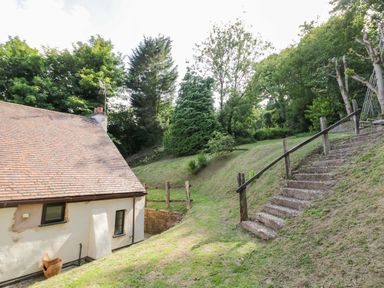 A garden with steps leading to the house at Fern Cottage