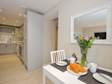 A dining room with a table set for breakfast at Evelyn in Looe