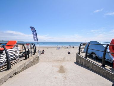A beach with chairs and a cafe at Evelyn in Looe