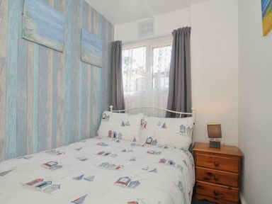 A bedroom with a bed and bedside table at 13 Hillside, Bude