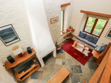 A living room with a sofa and coffee table at The Dovecote, Llanychaer near Fishguard
